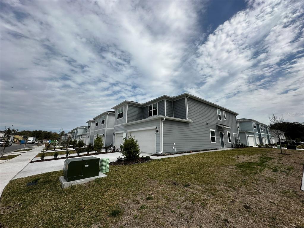 4806 Sparkling Shell Avenue Kissimmee, FL 34746 - Photo 2 of 19 a front view of a house with a yard