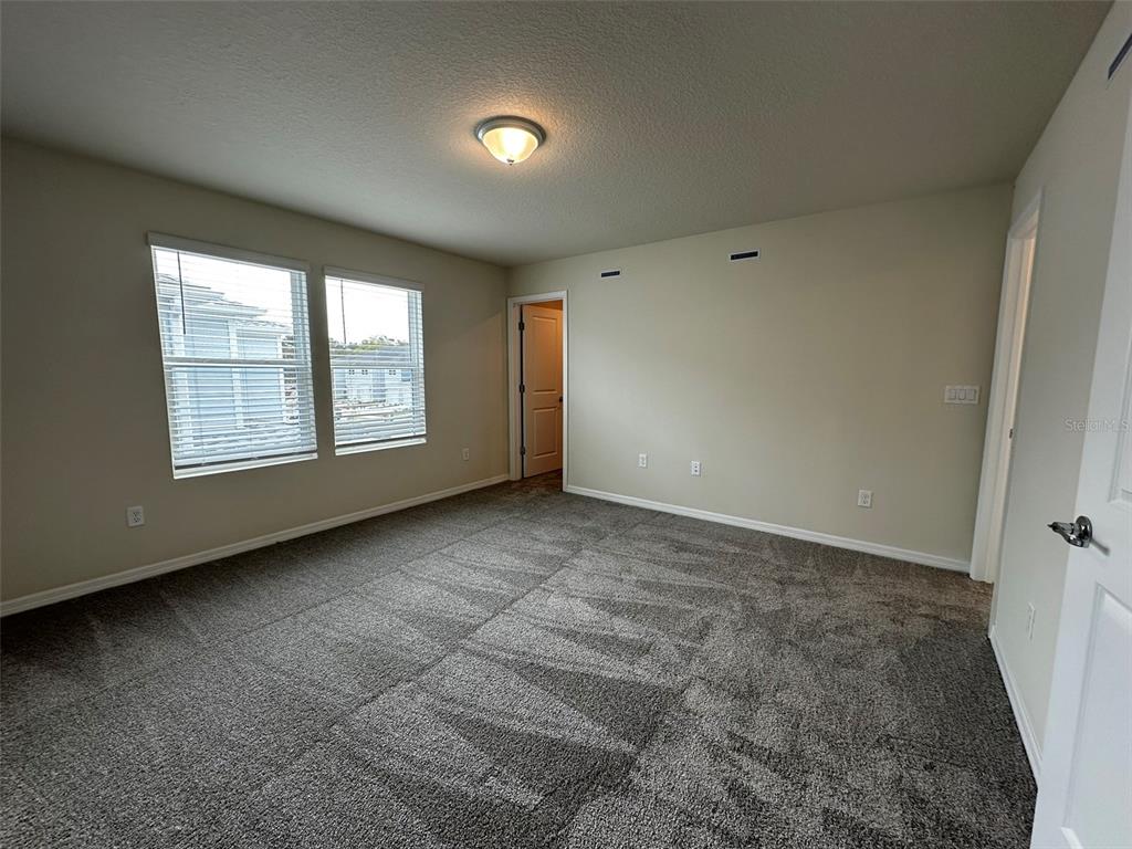 4806 Sparkling Shell Avenue Kissimmee, FL 34746 - Photo 9 of 19 an empty room with windows