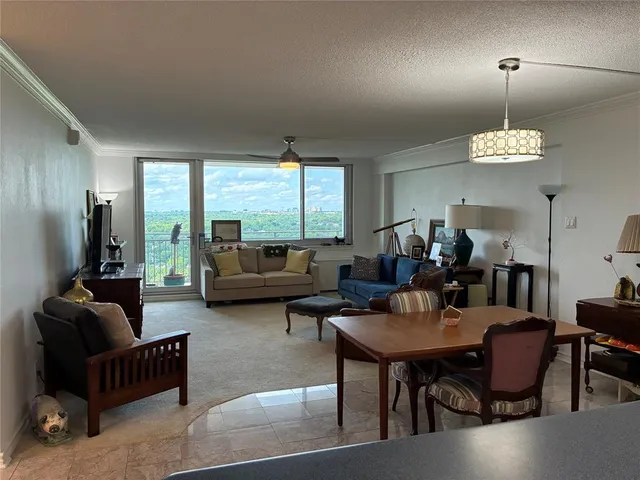 a living room with furniture wooden floor and a chandelier