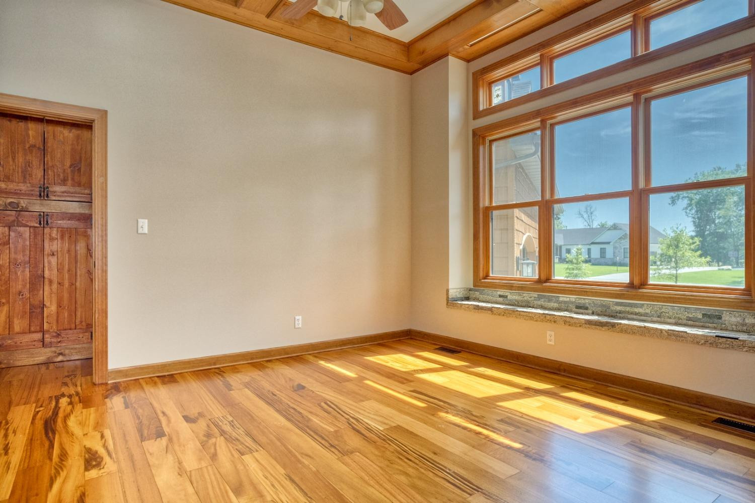 8468 Old Oak Drive Demotte, IN 46310 - Photo 16 of 35 a view of an empty room with a window and wooden floor