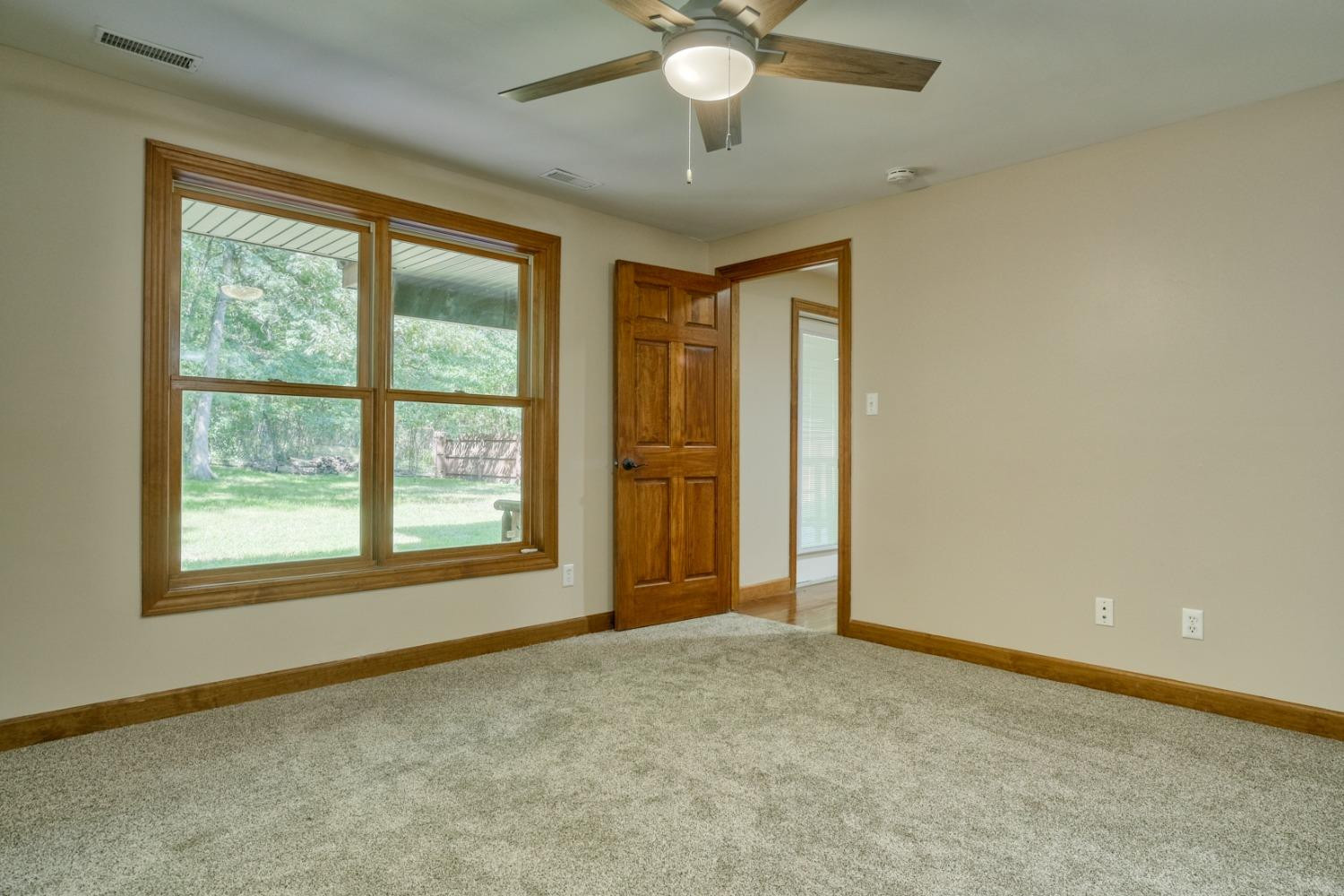 8468 Old Oak Drive Demotte, IN 46310 - Photo 29 of 35 an empty room with chandelier fan and windows