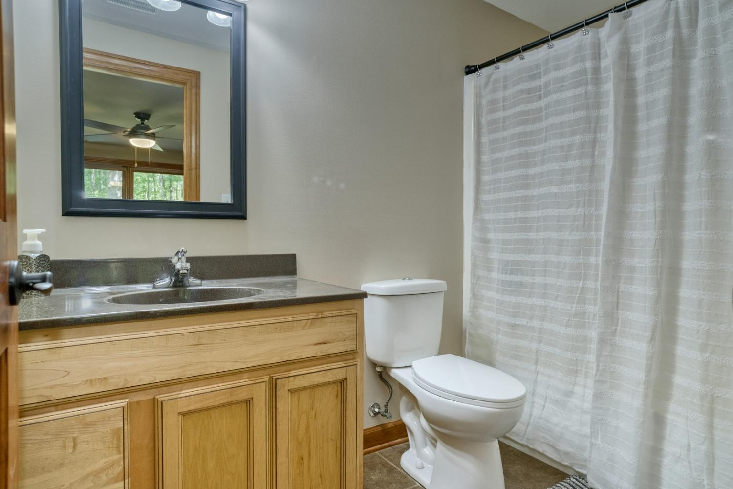 8468 Old Oak Drive Demotte, IN 46310 - Photo 30 of 35 a bathroom with a toilet a sink and mirror