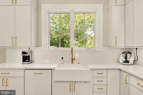 a bathroom with a double vanity sink a mirror and a bathtub