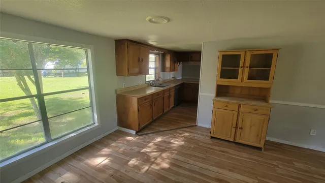 a kitchen with granite countertop a stove and a sink