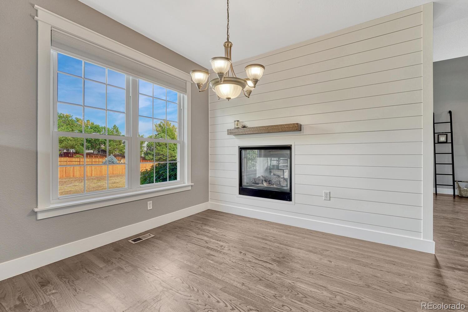 6335 Trailhead Road Highlands Ranch, CO 80130 - Photo 17 of 50 a view of an empty room with a fireplace and a window