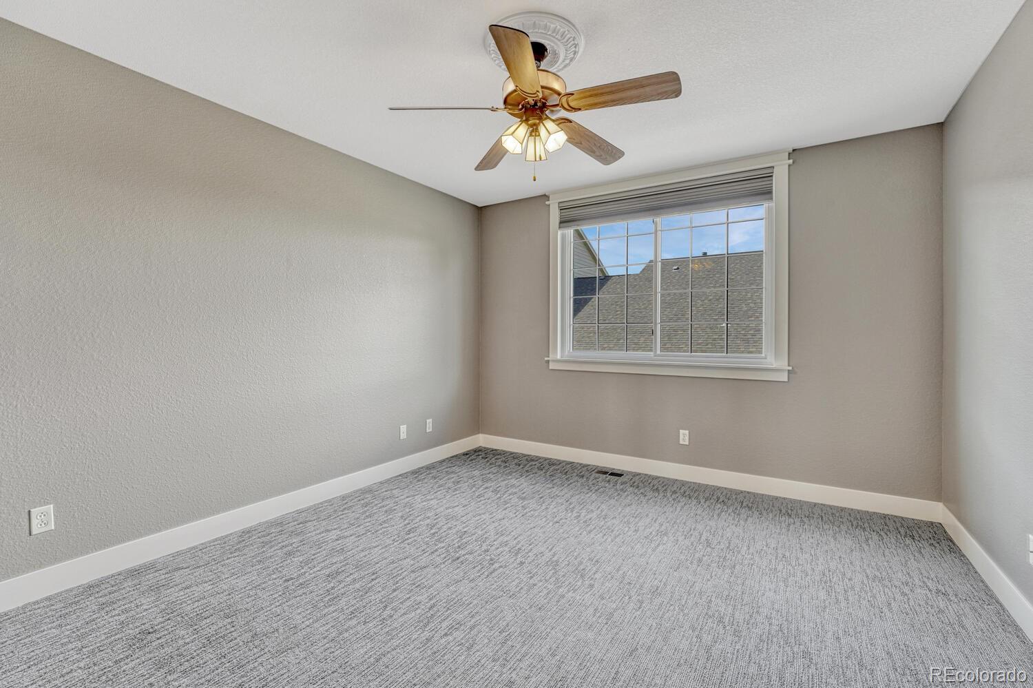 6335 Trailhead Road Highlands Ranch, CO 80130 - Photo 21 of 50 an empty room with a window and a fan