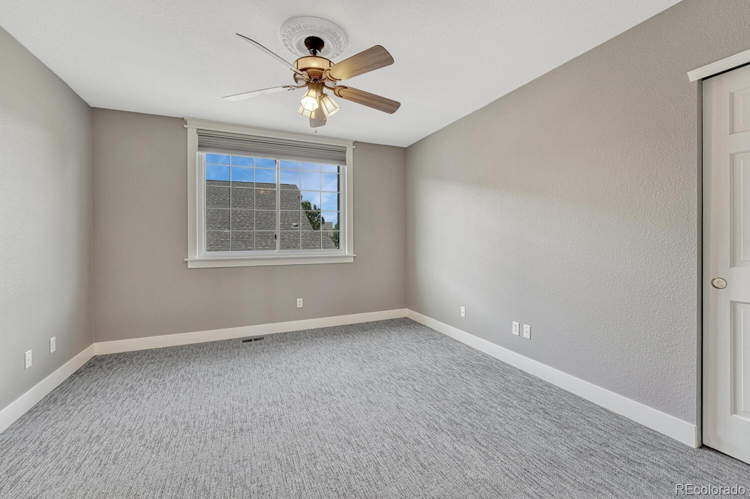 6335 Trailhead Road Highlands Ranch, CO 80130 - Photo 22 of 50 wooden floor in an empty room with a window