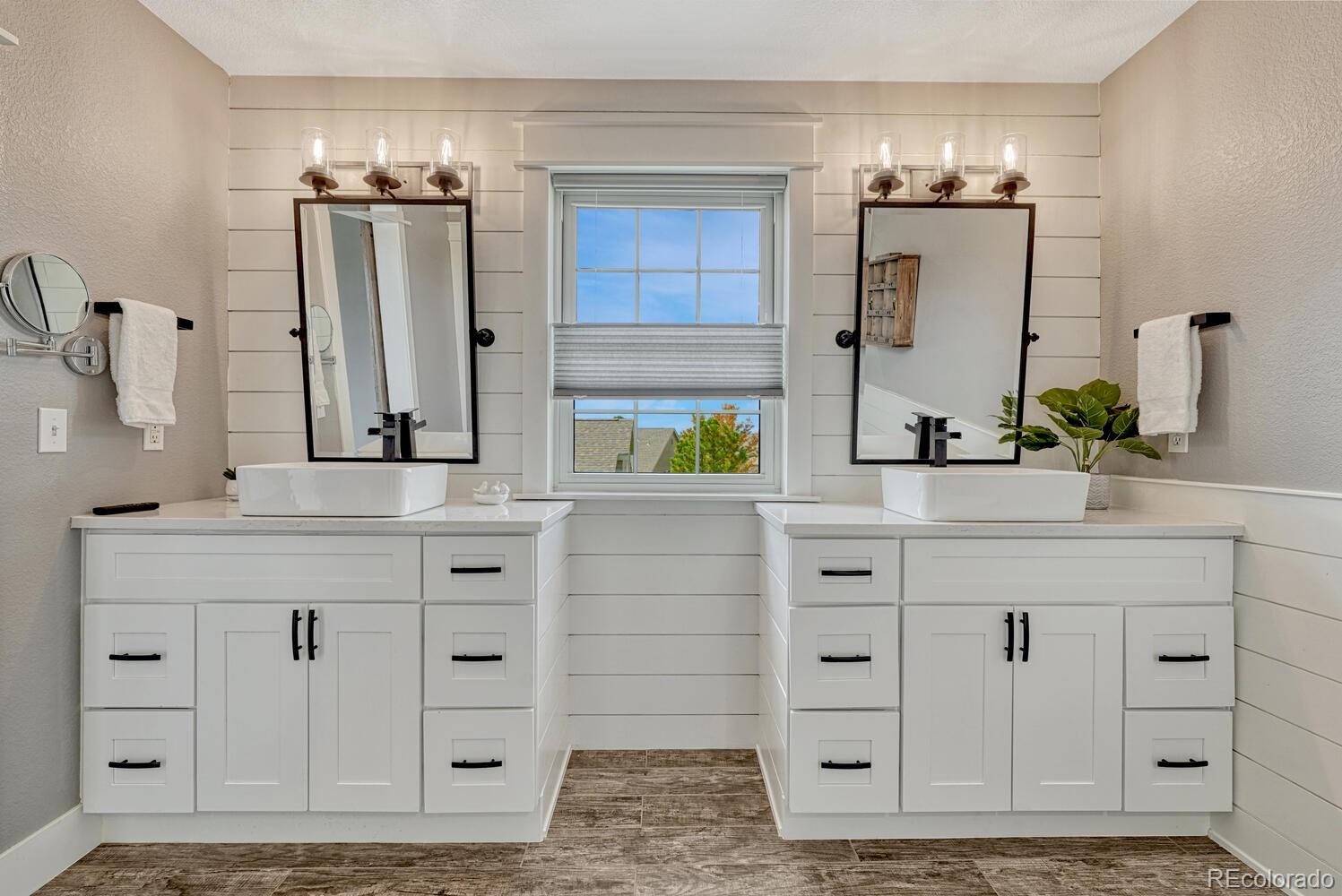 6335 Trailhead Road Highlands Ranch, CO 80130 - Photo 32 of 50 a bathroom with a sink vanity granite and a mirror