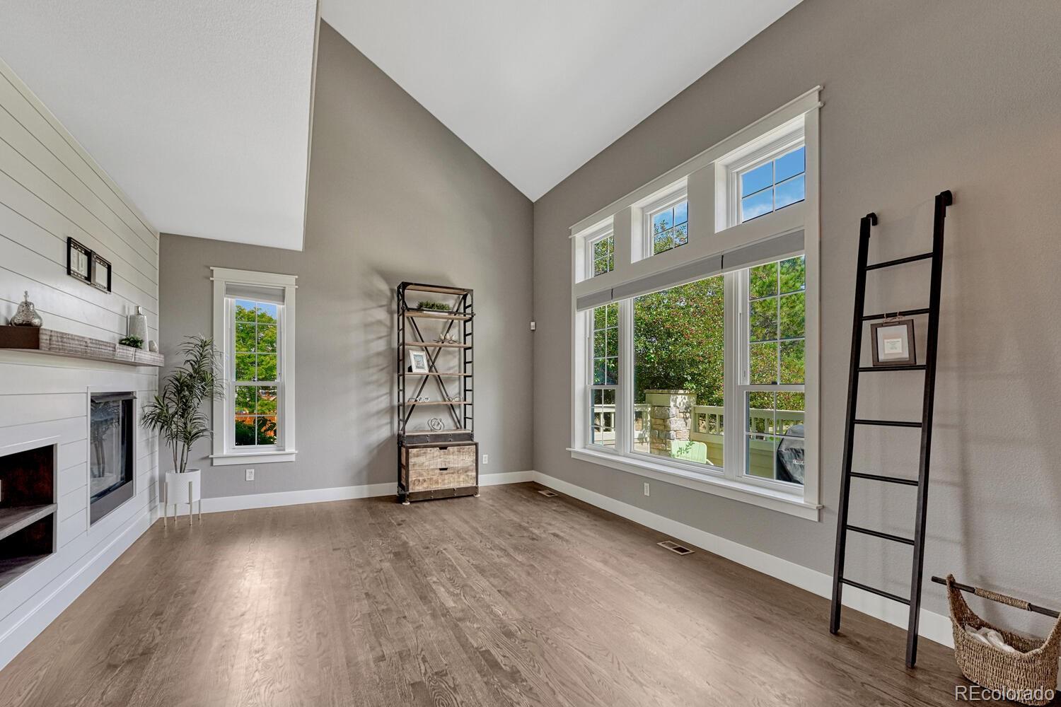 6335 Trailhead Road Highlands Ranch, CO 80130 - Photo 6 of 50 a view of an empty room with wooden floor and a window
