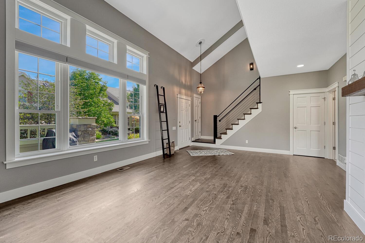 6335 Trailhead Road Highlands Ranch, CO 80130 - Photo 8 of 50 a view of an empty room with wooden floor and a window