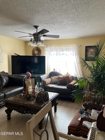 a living room with furniture a chandelier and a fireplace