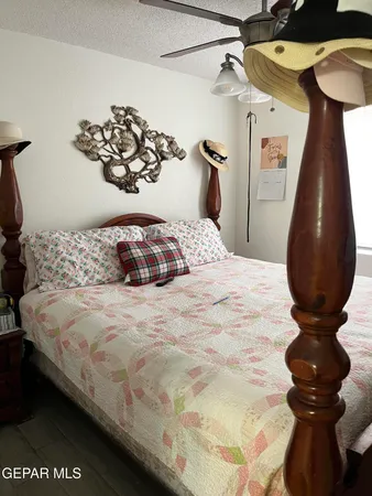 a bedroom with a bed and a painting on the wall