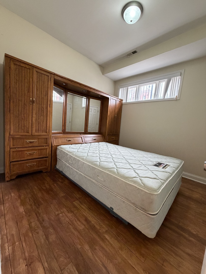 2355 West Harrison Street, Unit GDN Chicago, IL 60612 - Photo 12 of 14 a bedroom with a bed and window