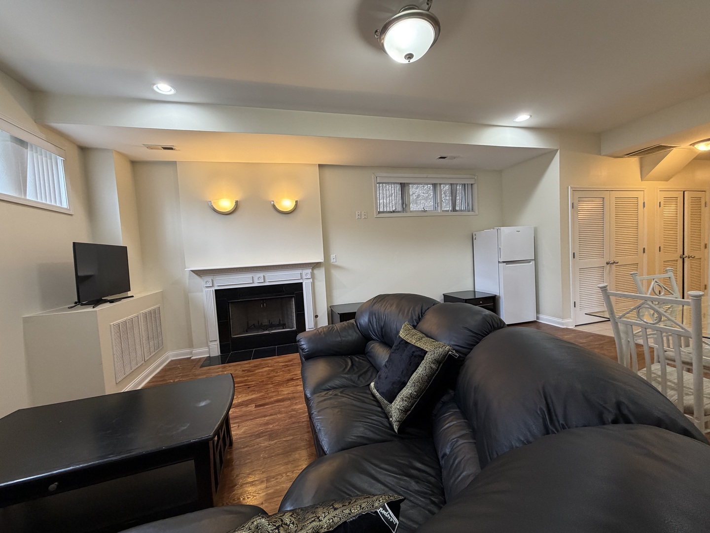 2355 West Harrison Street, Unit GDN Chicago, IL 60612 - Photo 4 of 14 a living room with furniture a flat screen tv and a fireplace