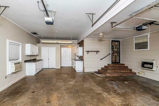 a view of a kitchen with a sink and a refrigerator