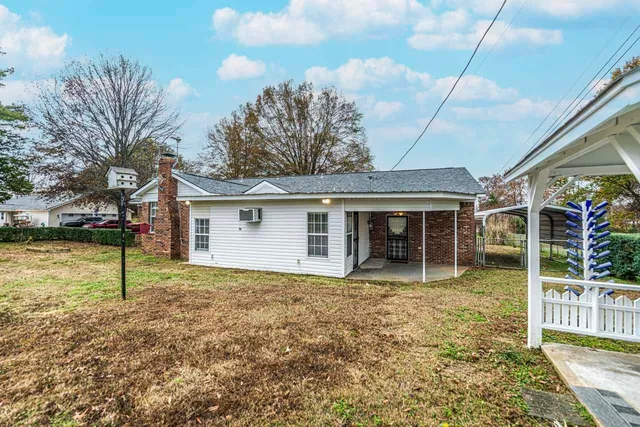a house with lots of trees in the background