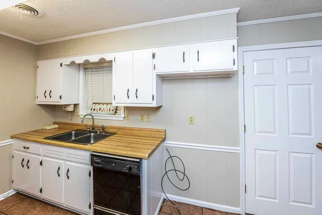 a kitchen with a sink and cabinets