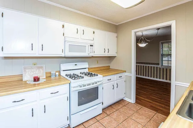 a kitchen with a stove top oven and cabinets