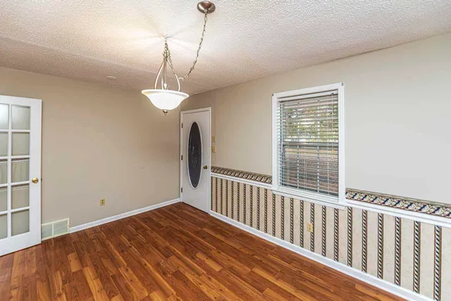 a view of a livingroom with wooden floor and a window