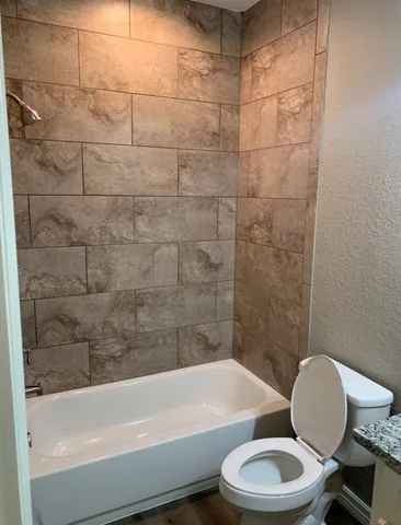 a bathroom with a toilet a sink and bathtub