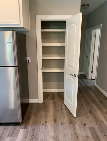 a view of walk in closet with empty racks