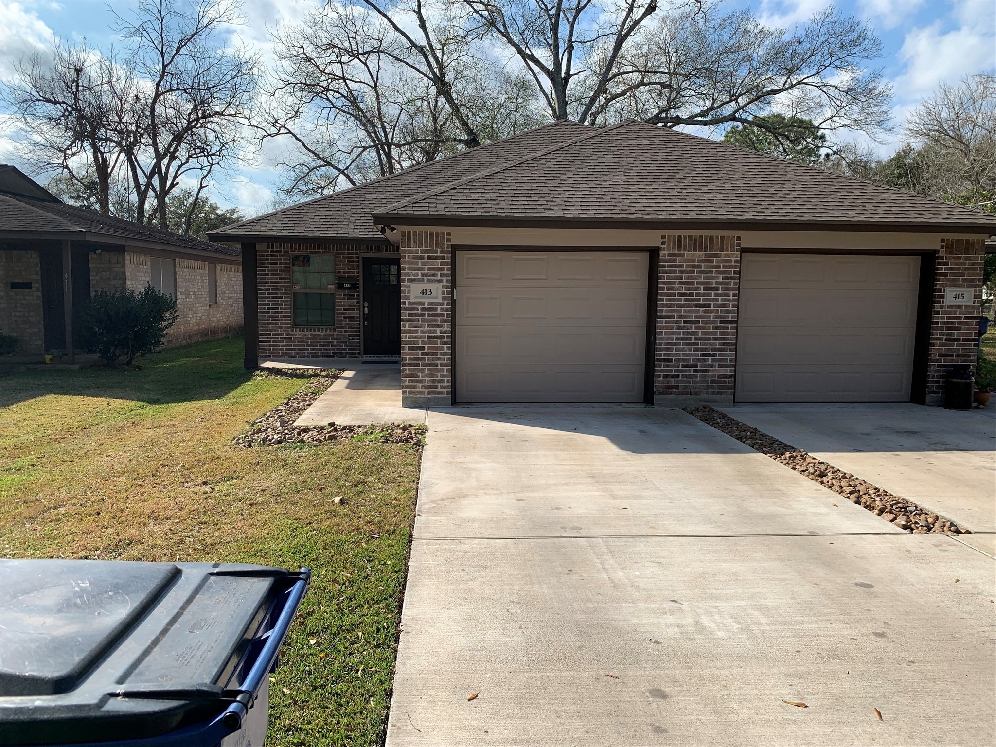 413-415 Hurst Place Angleton, TX 77515 - Photo 19 of 19 a front view of a house with a yard and garage