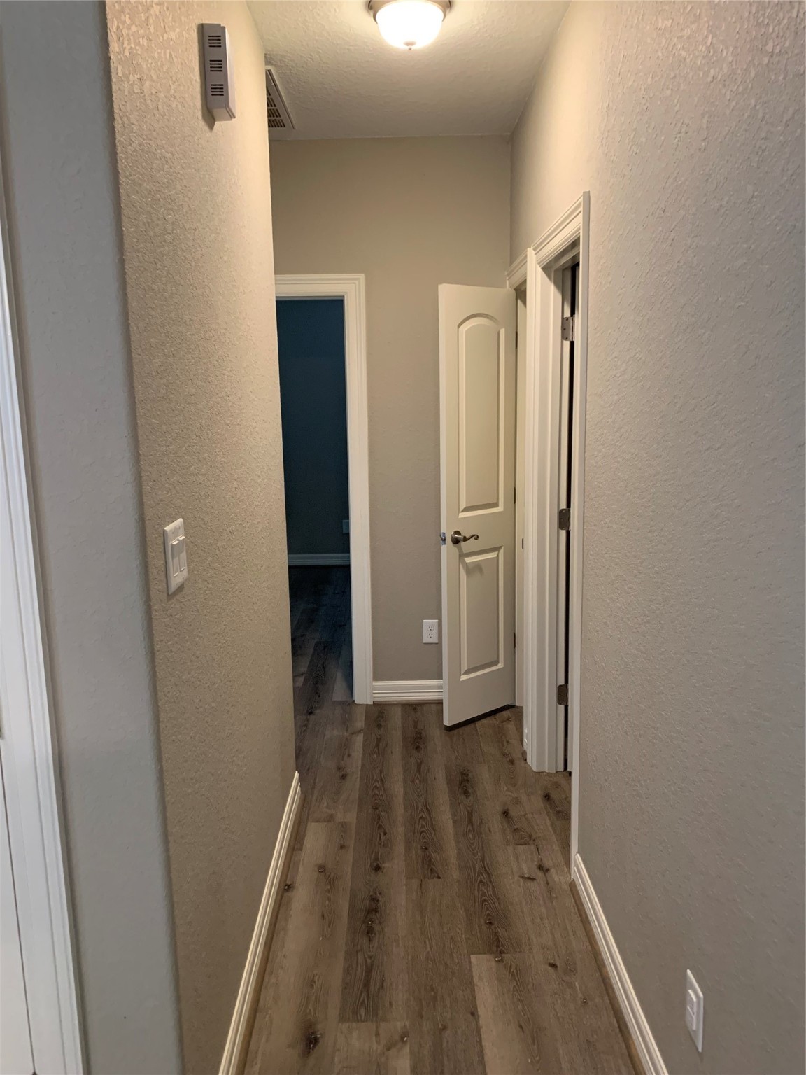 413-415 Hurst Place Angleton, TX 77515 - Photo 5 of 19 a view of a hallway with wooden floor and closet area