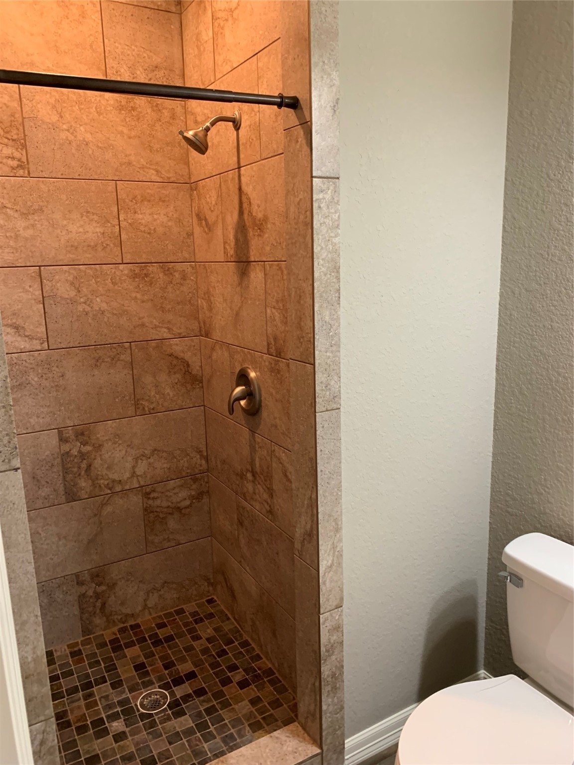 413-415 Hurst Place Angleton, TX 77515 - Photo 9 of 19 a bathroom with a toilet and a shower