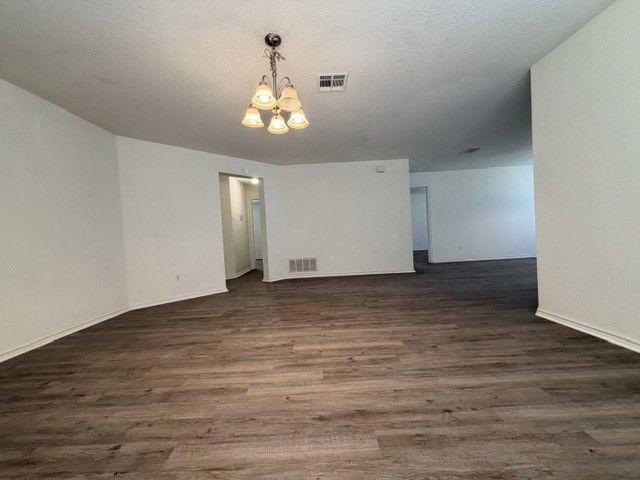 18421 Crestwind Lane Elgin, TX 78621 - Photo 6 of 34 Rich wood-look flooring anchors this open living space with neutral walls.