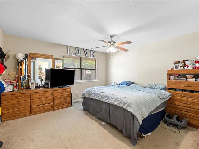 a bedroom with a bed and flat screen tv