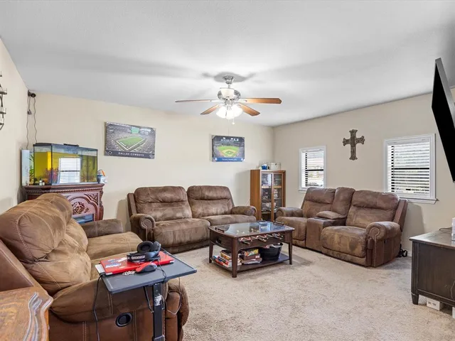a living room with furniture a couch and a window
