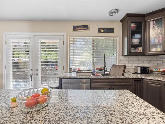 a kitchen with a stove a sink and a dining table