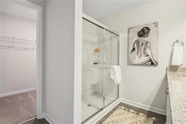 a bathroom with a glass shower door