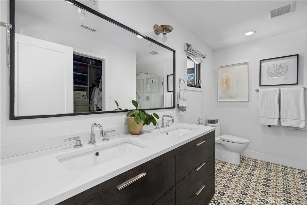 338 Bucknell Road Costa Mesa, CA 92626 - Photo 18 of 25 a bathroom with a double vanity sink mirror and toilet