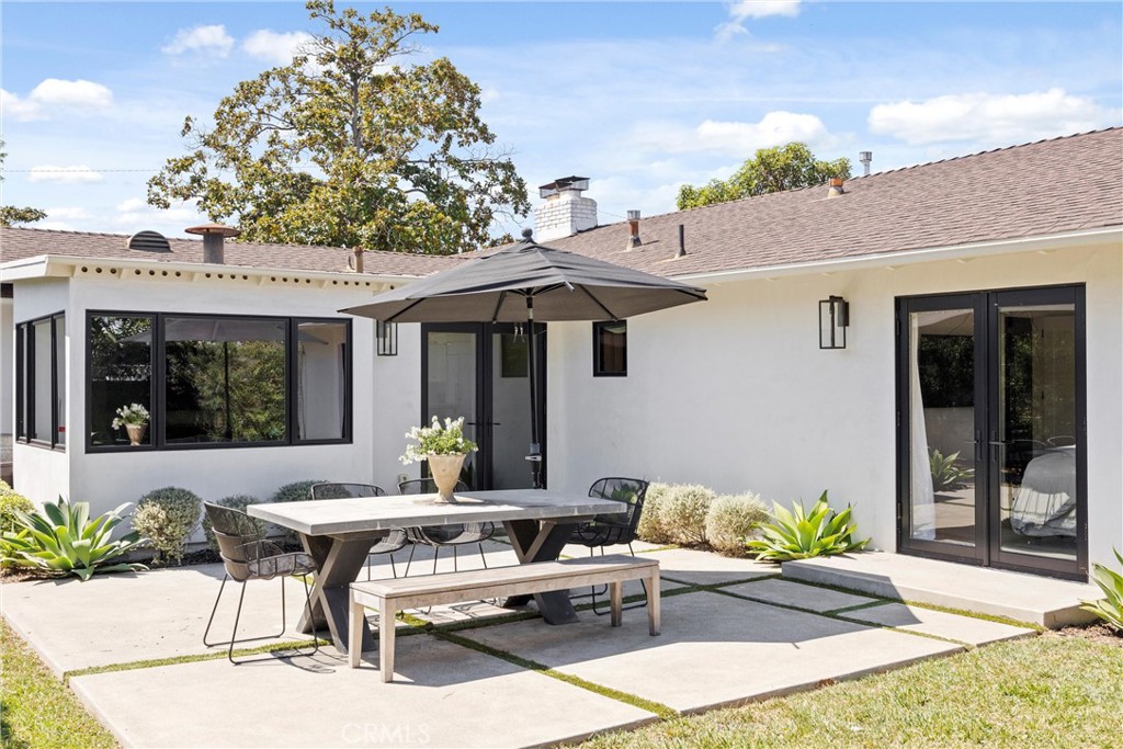 338 Bucknell Road Costa Mesa, CA 92626 - Photo 21 of 25 a view of a patio with table and chairs potted plants with wooden fence