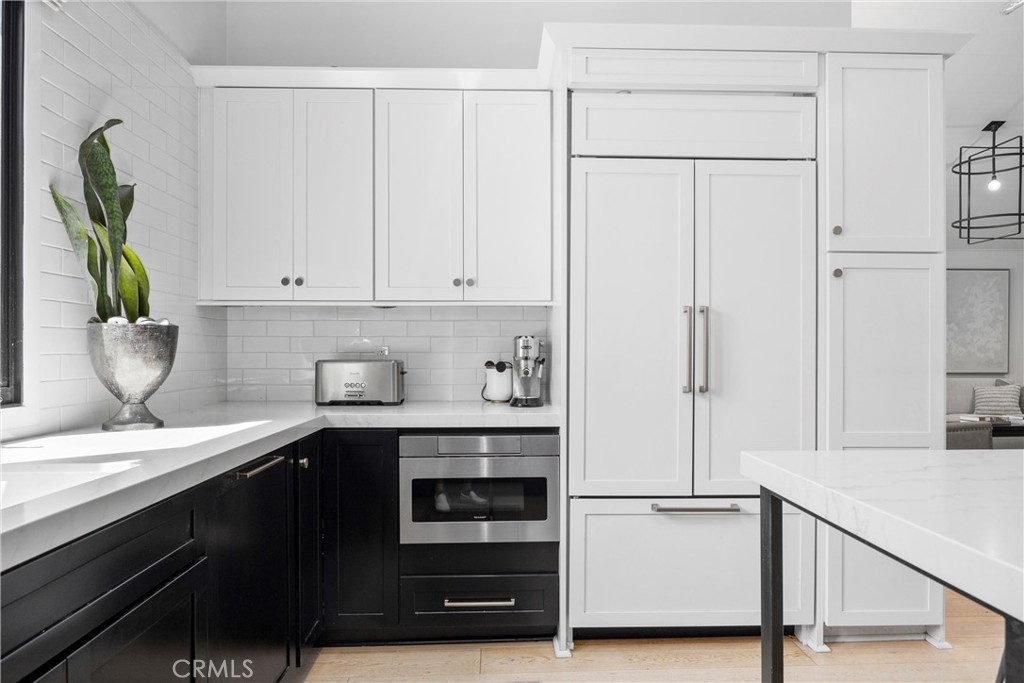 338 Bucknell Road Costa Mesa, CA 92626 - Photo 7 of 25 a kitchen with a sink and white cabinets