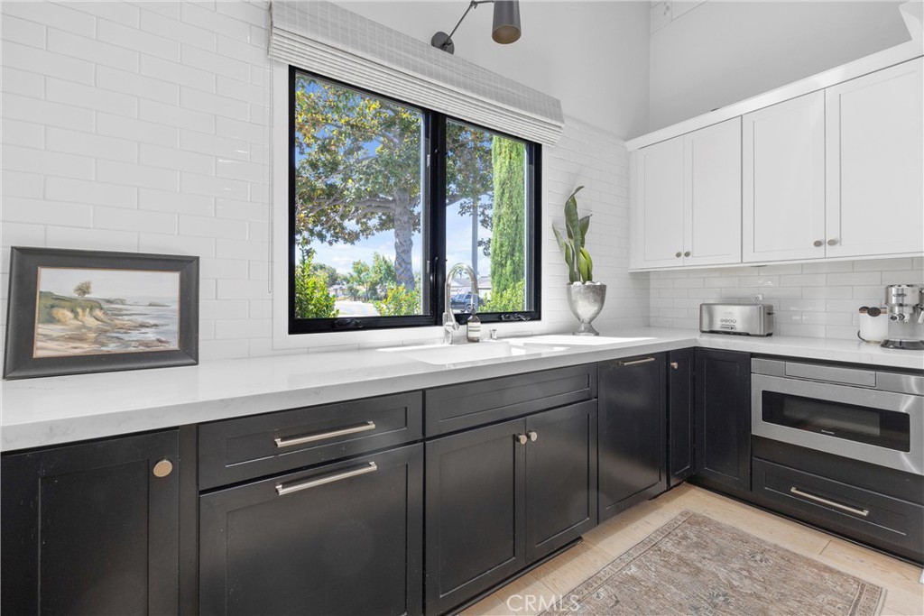 338 Bucknell Road Costa Mesa, CA 92626 - Photo 8 of 25 a kitchen with stainless steel appliances sink cabinets and window
