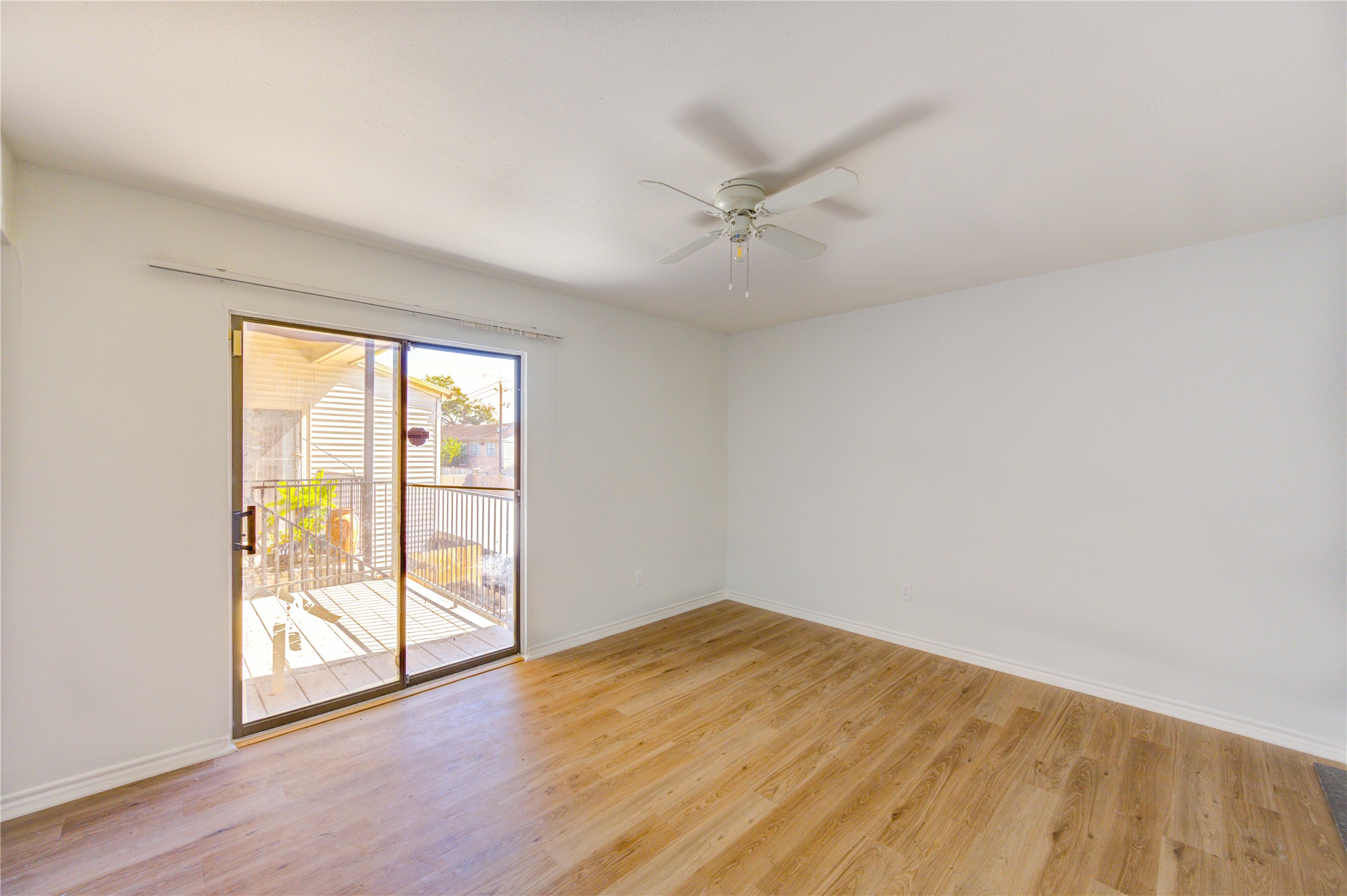 6401 Deihl Road, Unit 505 Houston, TX 77092 - Photo 27 of 35 an empty room with wooden floor fan and windows