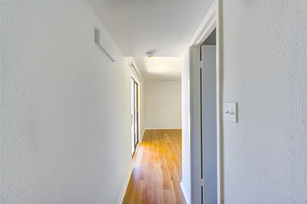 a view of hallway with wooden floor