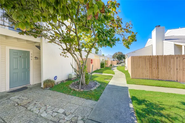 a front view of a house with a yard and trees
