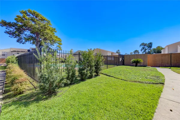 a view of green field with wooden fence