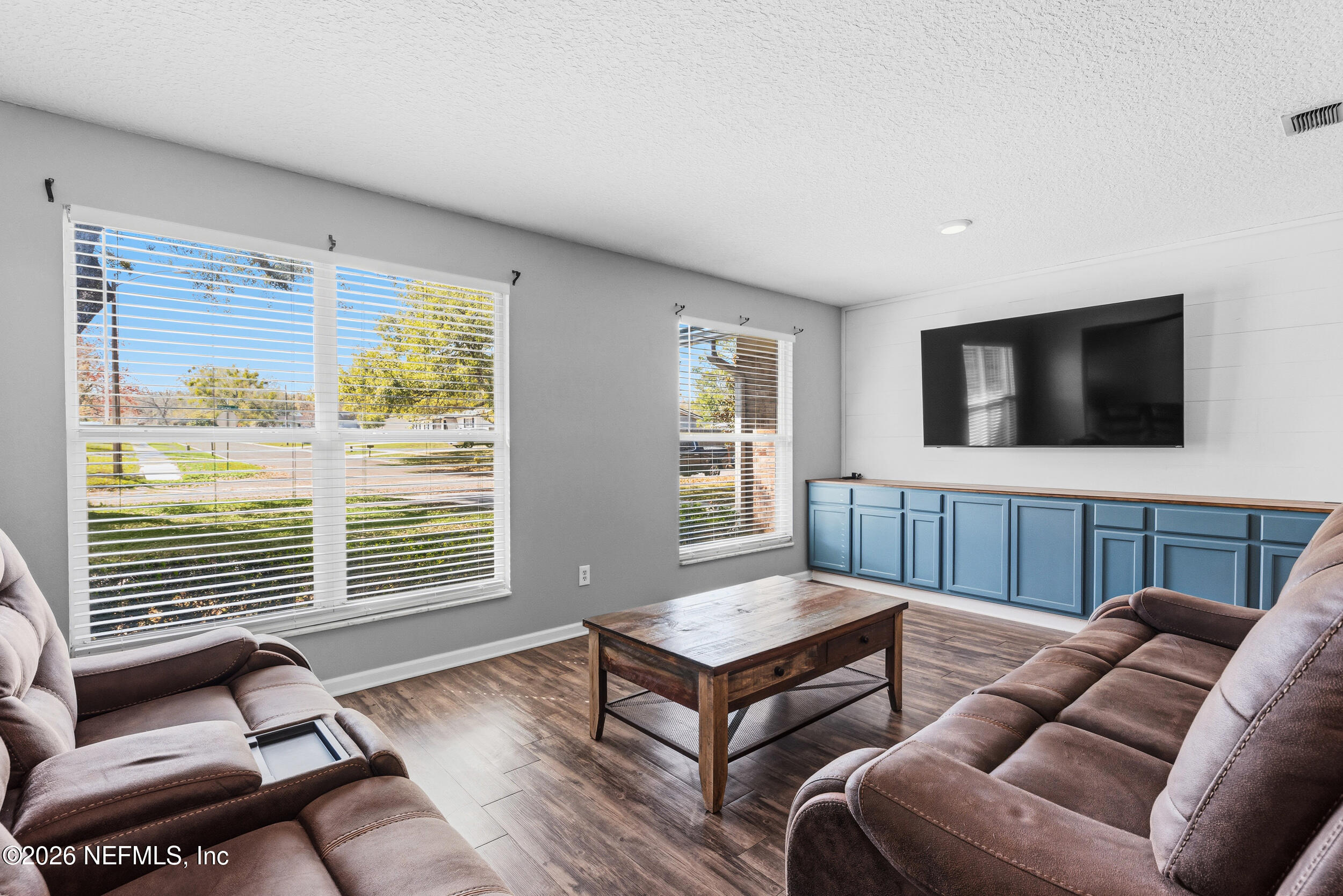 8729 Pinon Drive Jacksonville, FL 32221 - Photo 11 of 33 a living room with furniture and a flat screen tv
