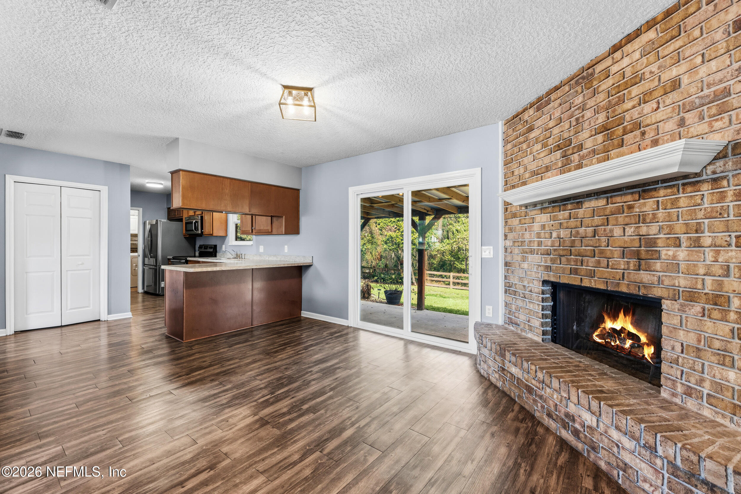 8729 Pinon Drive Jacksonville, FL 32221 - Photo 15 of 33 a living room with furniture and a fireplace