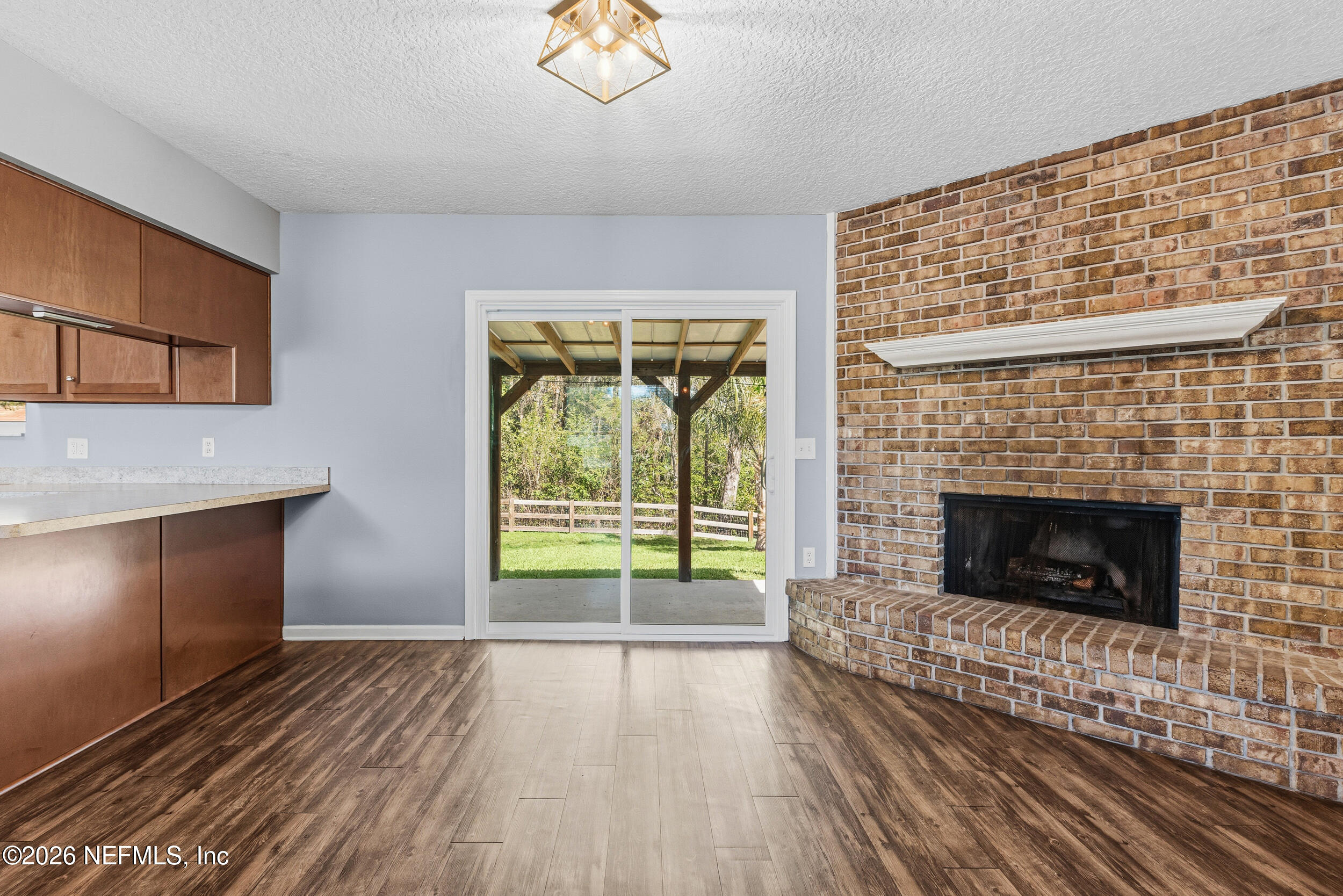 8729 Pinon Drive Jacksonville, FL 32221 - Photo 16 of 33 a view of an empty room with a fireplace and a window