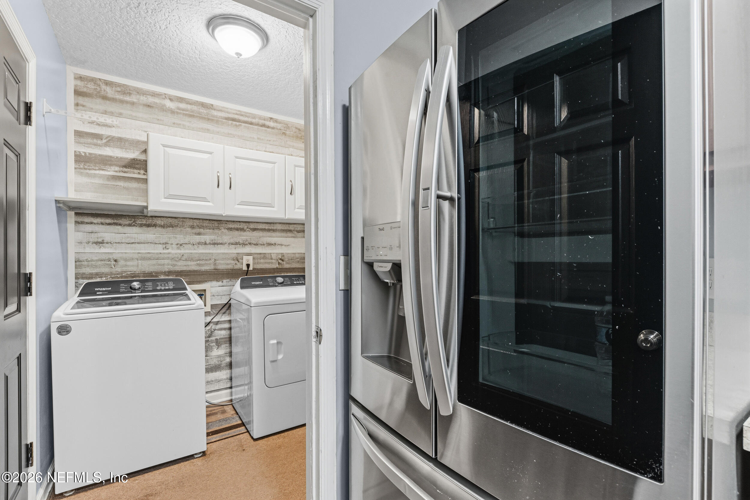 8729 Pinon Drive Jacksonville, FL 32221 - Photo 21 of 33 a kitchen with white cabinets and a refrigerator