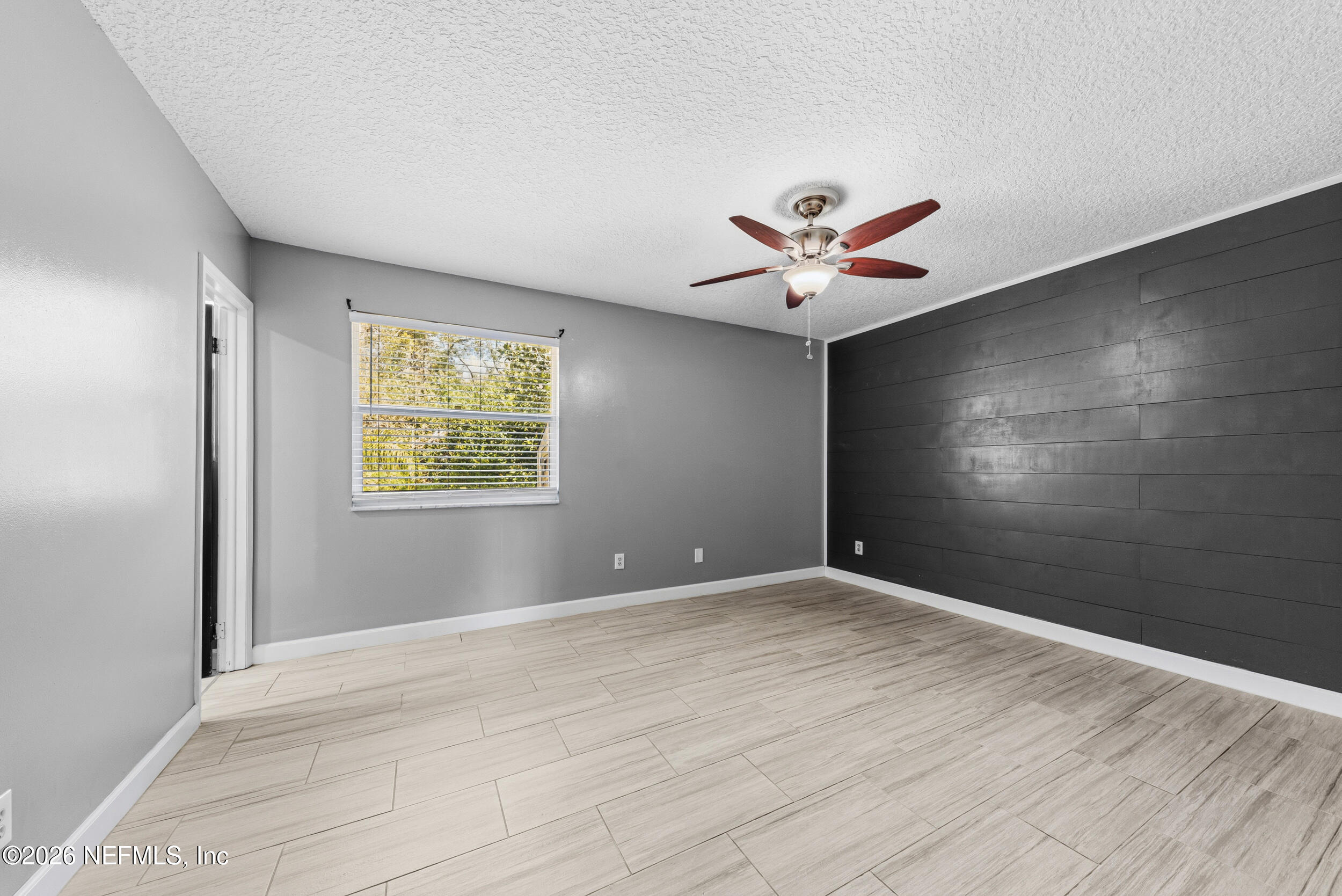 8729 Pinon Drive Jacksonville, FL 32221 - Photo 23 of 33 an empty room with ceiling fan and window