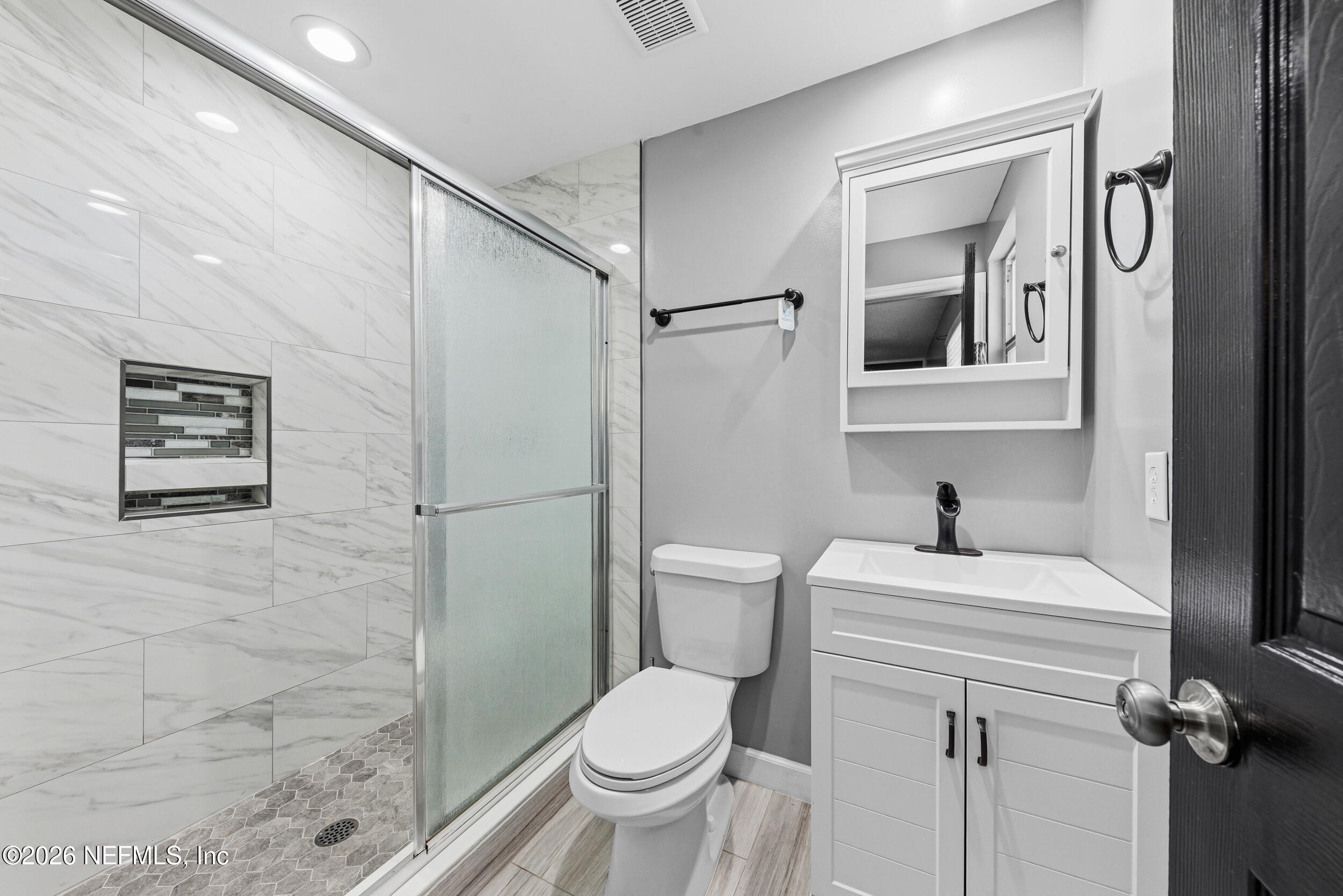 8729 Pinon Drive Jacksonville, FL 32221 - Photo 25 of 33 a white toilet sitting next to a bathroom sink