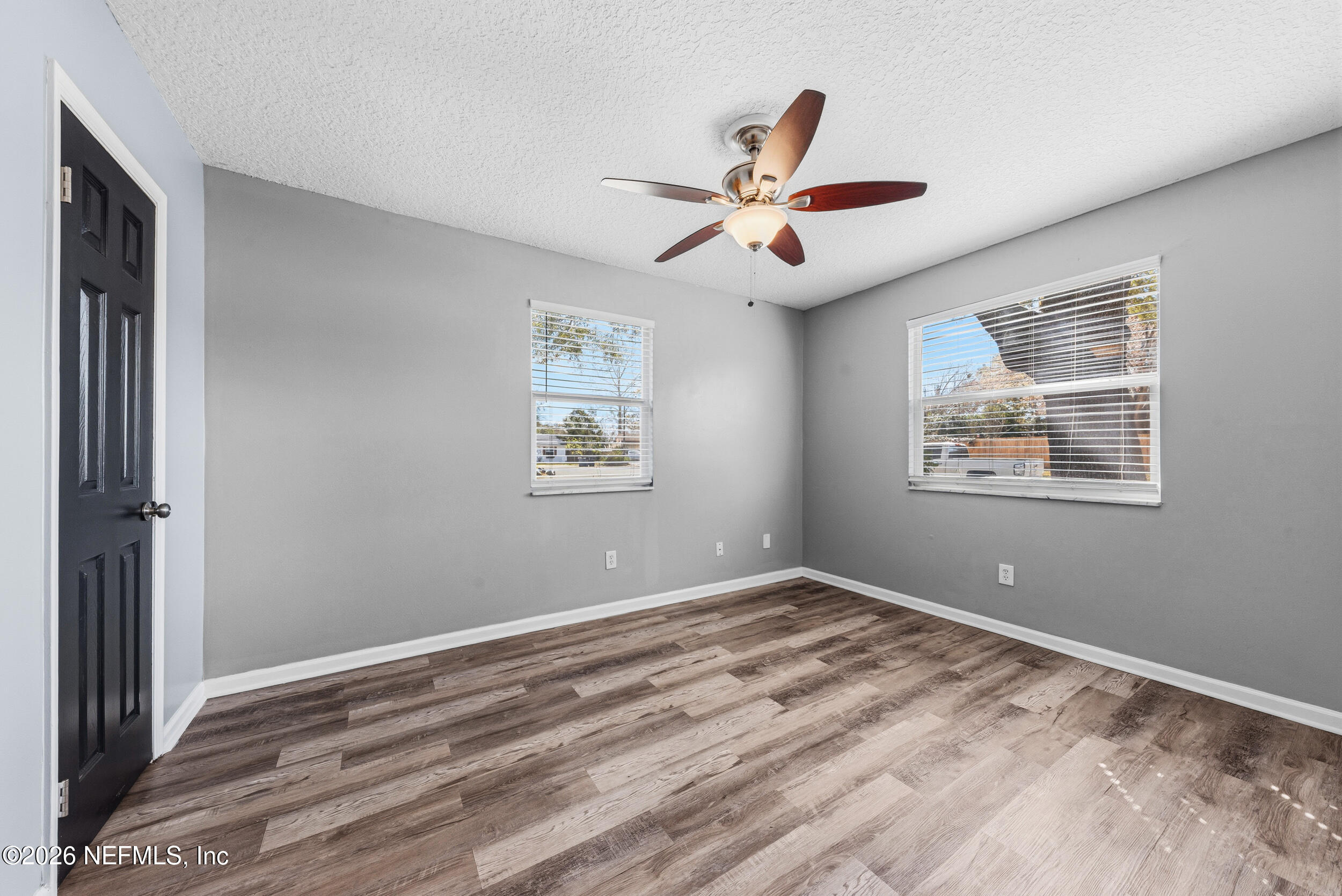 8729 Pinon Drive Jacksonville, FL 32221 - Photo 26 of 33 a view of a big room with wooden floor and windows