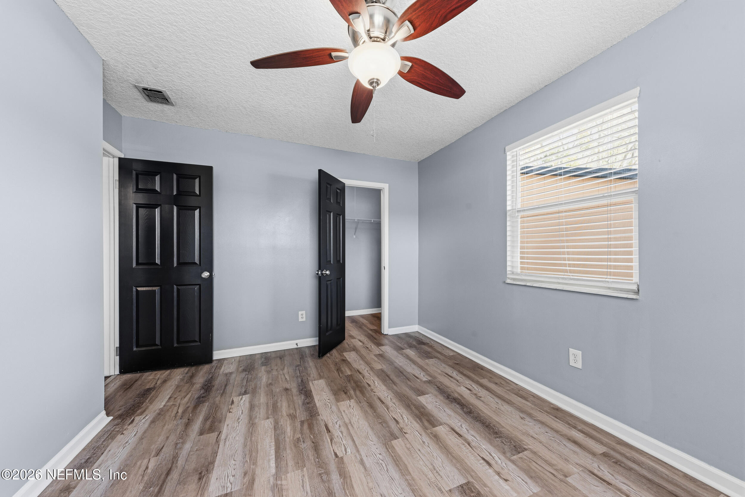 8729 Pinon Drive Jacksonville, FL 32221 - Photo 27 of 33 a view of a room with a ceiling fan and a window