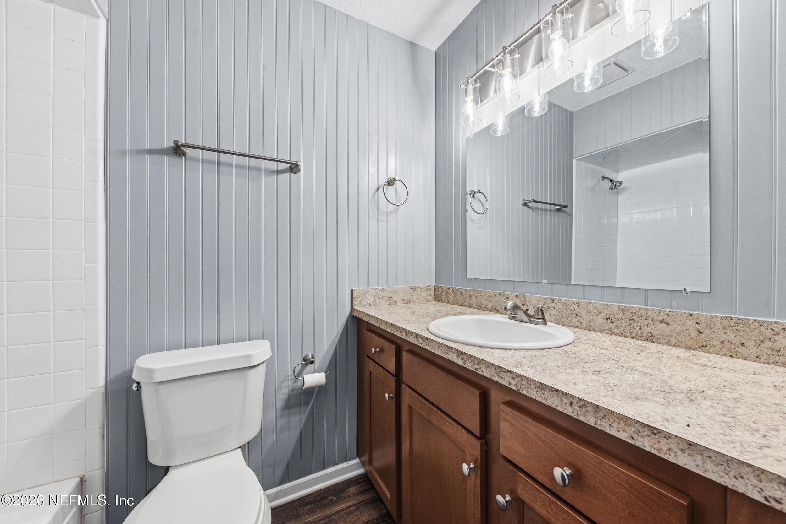 8729 Pinon Drive Jacksonville, FL 32221 - Photo 30 of 33 a bathroom with a granite countertop sink a toilet and a mirror